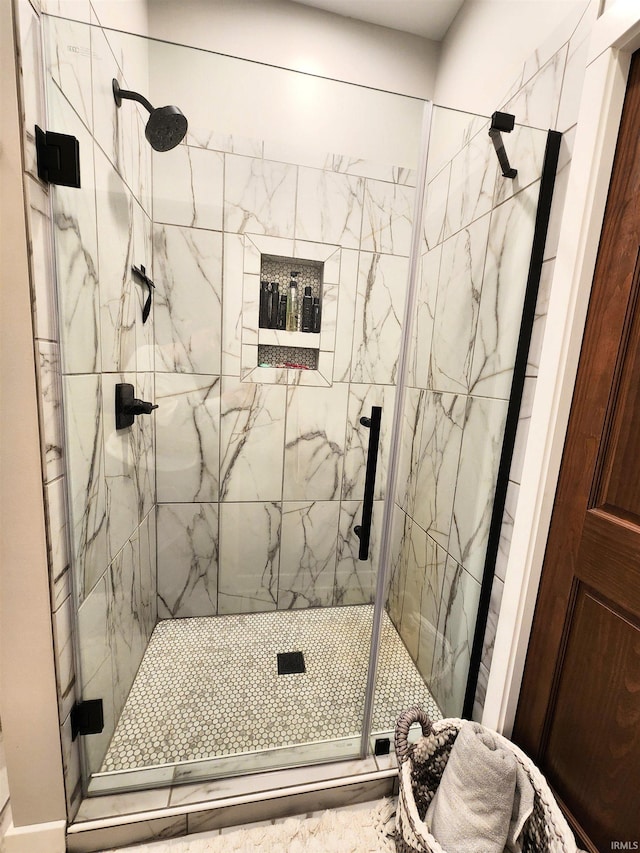 bathroom with a shower with door