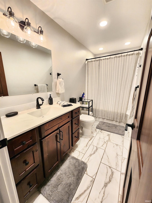 bathroom featuring vanity and toilet