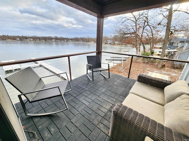 view of patio / terrace featuring outdoor lounge area, a water view, and a balcony