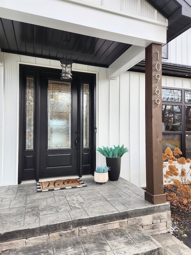 view of exterior entry with a porch