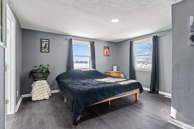 bedroom featuring dark wood-type flooring and a textured ceiling