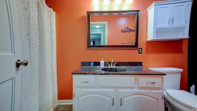 bathroom with vanity, toilet, and walk in shower