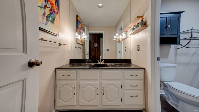 bathroom featuring vanity and toilet