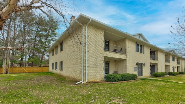 view of side of home with a yard