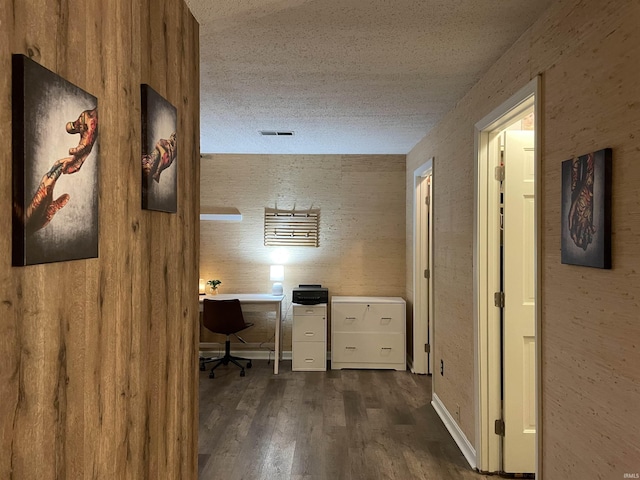 office featuring a textured ceiling and dark wood-type flooring