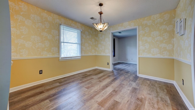 spare room with hardwood / wood-style floors