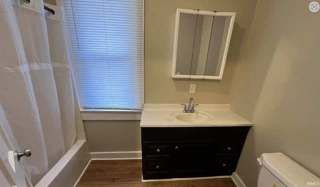 full bathroom with wood-type flooring, vanity, toilet, and shower / bath combination with curtain