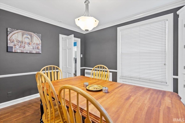 dining space featuring dark hardwood / wood-style flooring and ornamental molding