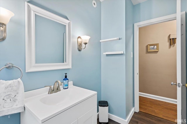 bathroom with hardwood / wood-style floors and vanity