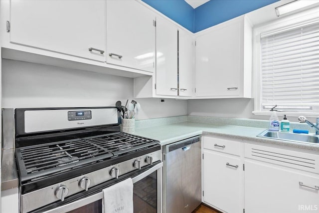 kitchen with white cabinetry, sink, and appliances with stainless steel finishes