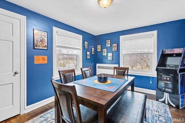 dining room featuring dark hardwood / wood-style floors and radiator