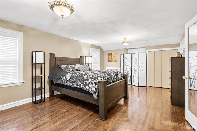 bedroom featuring hardwood / wood-style floors and multiple windows