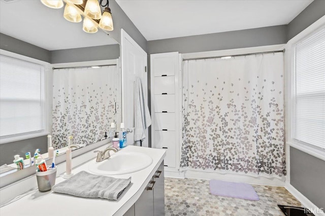 bathroom featuring vanity and an inviting chandelier