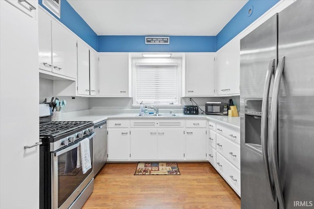 kitchen featuring sink, white cabinets, and stainless steel appliances