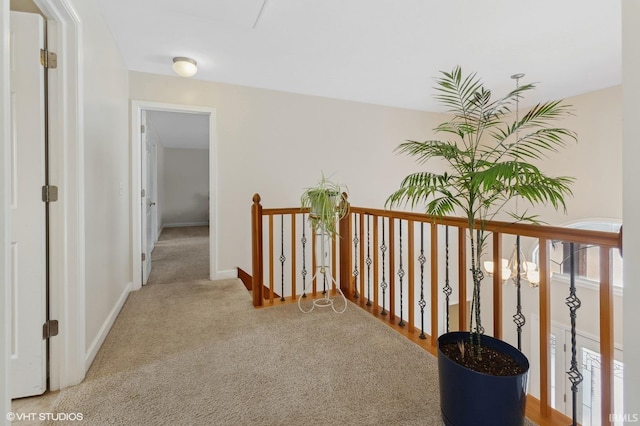 hallway with baseboards and carpet flooring