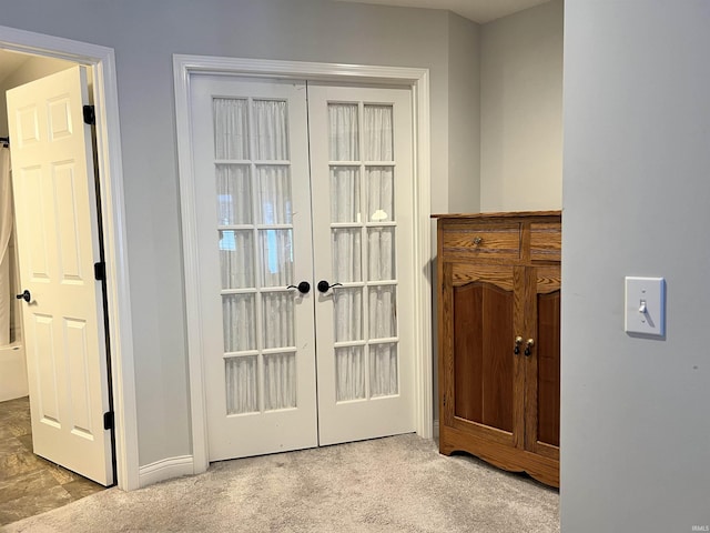 doorway to outside featuring light colored carpet and french doors