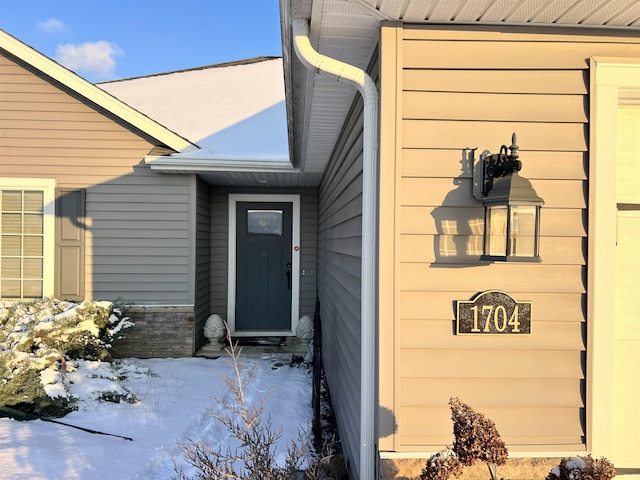 view of snow covered property entrance