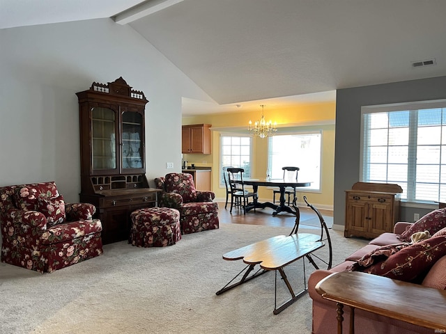 living room featuring light carpet, lofted ceiling with beams, and an inviting chandelier