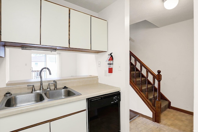 kitchen with dishwasher, white cabinets, and sink