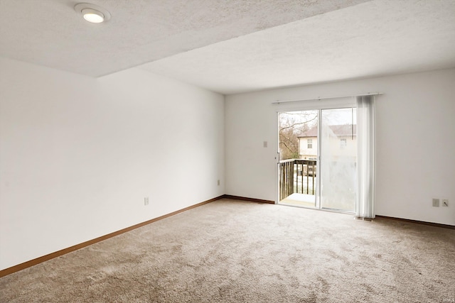 empty room featuring carpet flooring and a textured ceiling