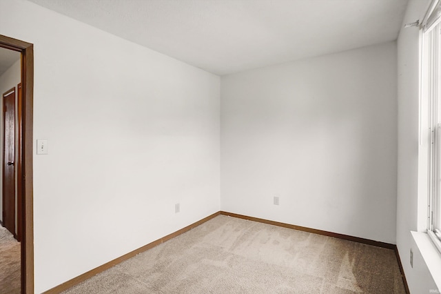 carpeted empty room featuring plenty of natural light