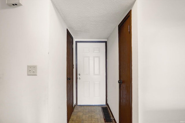 corridor with a textured ceiling