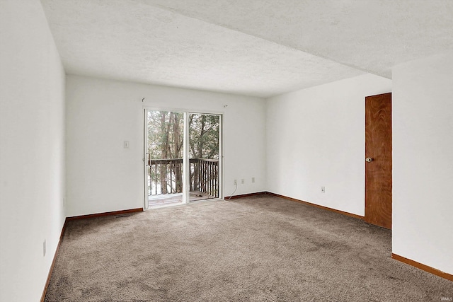 carpeted spare room with a textured ceiling