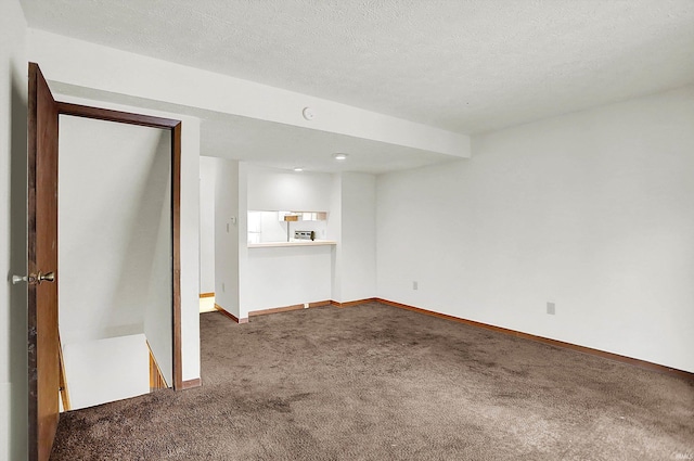 basement featuring carpet floors and a textured ceiling