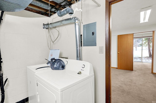 clothes washing area with light carpet, electric panel, and washer and clothes dryer