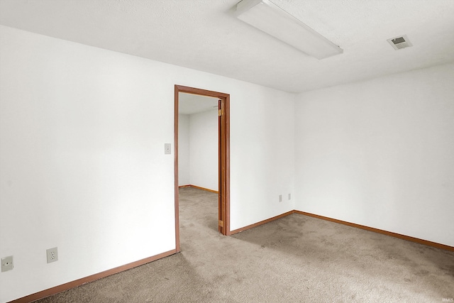 empty room featuring light colored carpet