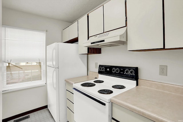 kitchen featuring white cabinetry and electric stove