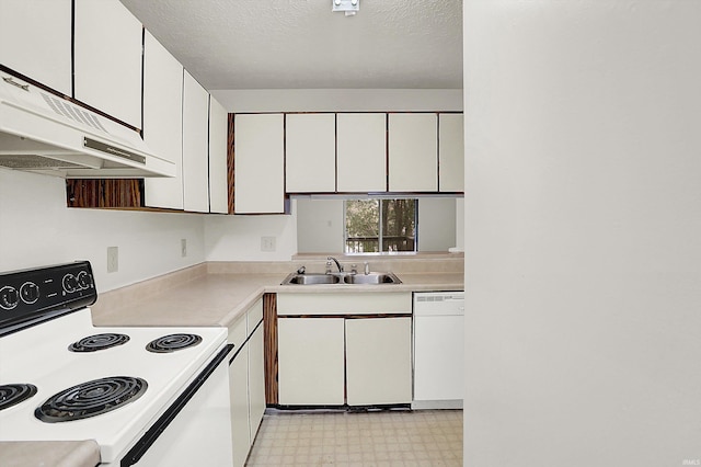 kitchen with white appliances, a textured ceiling, exhaust hood, sink, and white cabinets