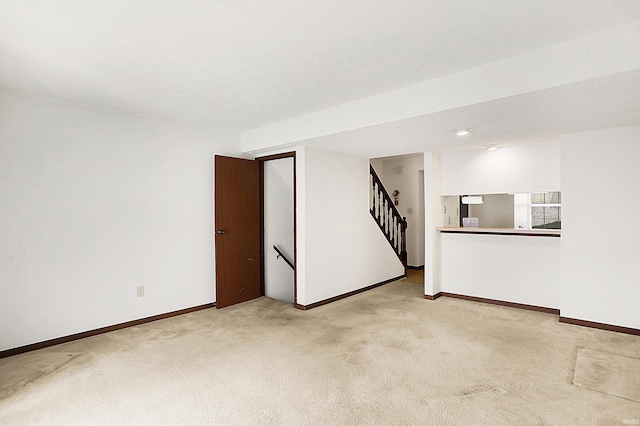 spare room featuring light colored carpet