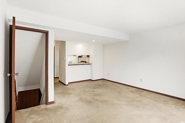 unfurnished living room with light colored carpet