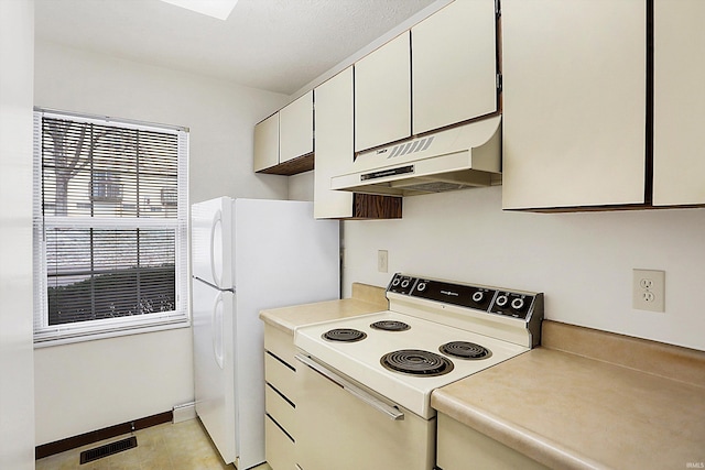 kitchen with white cabinets and white appliances