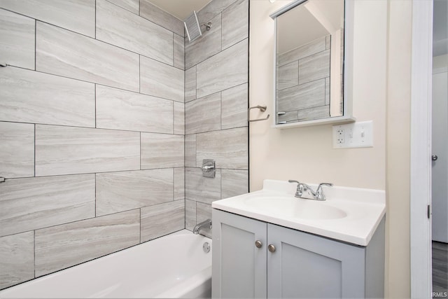 bathroom featuring vanity and tiled shower / bath