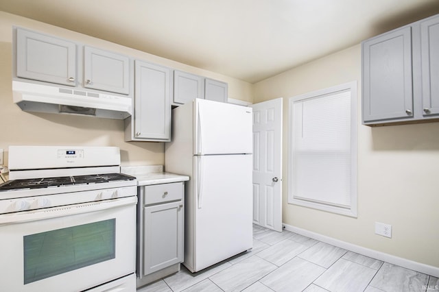 kitchen featuring gray cabinets and white appliances