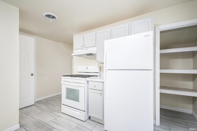 kitchen featuring white cabinetry and white appliances