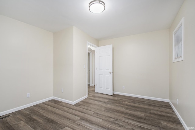 empty room featuring dark wood-type flooring