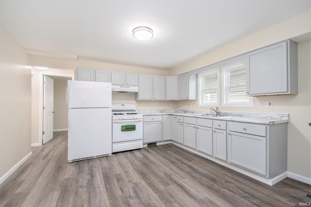 kitchen featuring light hardwood / wood-style flooring, white appliances, and sink