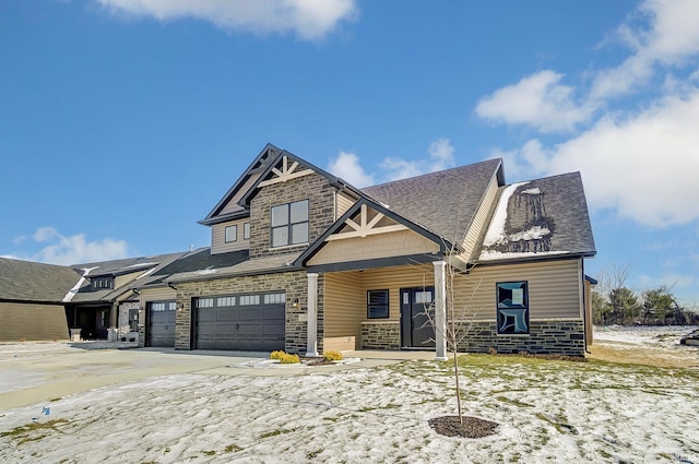 craftsman inspired home with covered porch and a garage