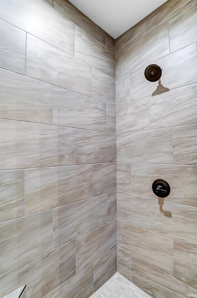 bathroom with a tile shower