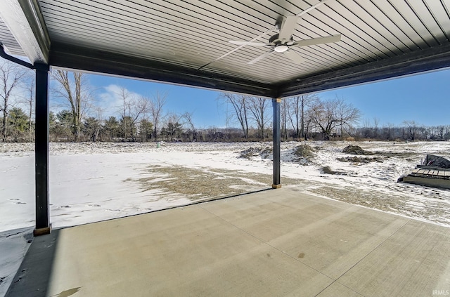 snow covered patio featuring ceiling fan