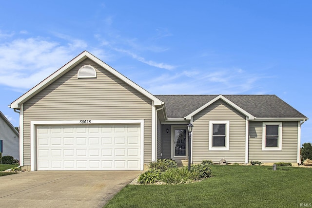 ranch-style home with a garage and a front lawn