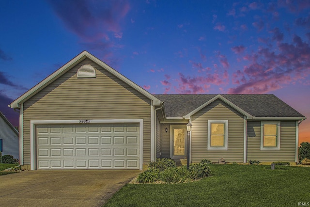 ranch-style home with a yard and a garage