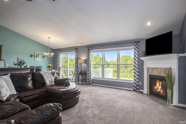 living room with a fireplace, carpet floors, vaulted ceiling, and an inviting chandelier