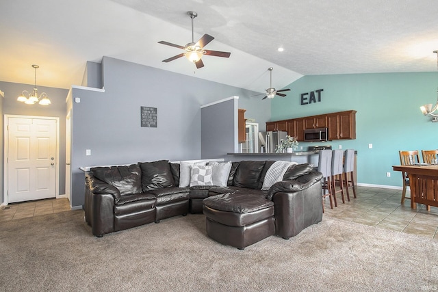 living room featuring lofted ceiling, light tile patterned floors, and ceiling fan with notable chandelier