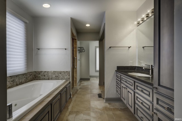 bathroom with vanity and a bath