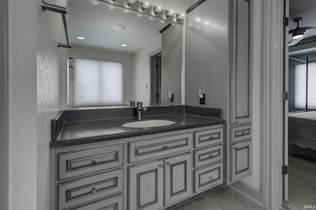 bathroom featuring tile patterned floors, vanity, and ceiling fan