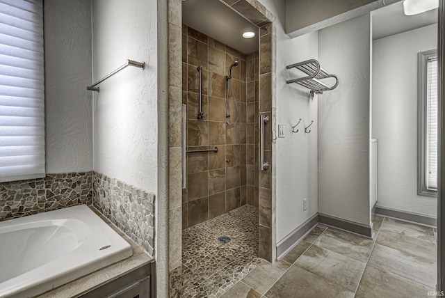 bathroom with separate shower and tub